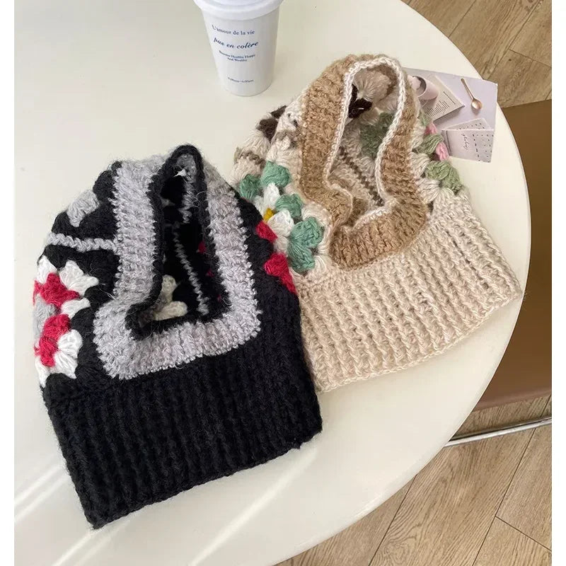 Two crocheted handbags with floral designs beside a White Knit Balaclava