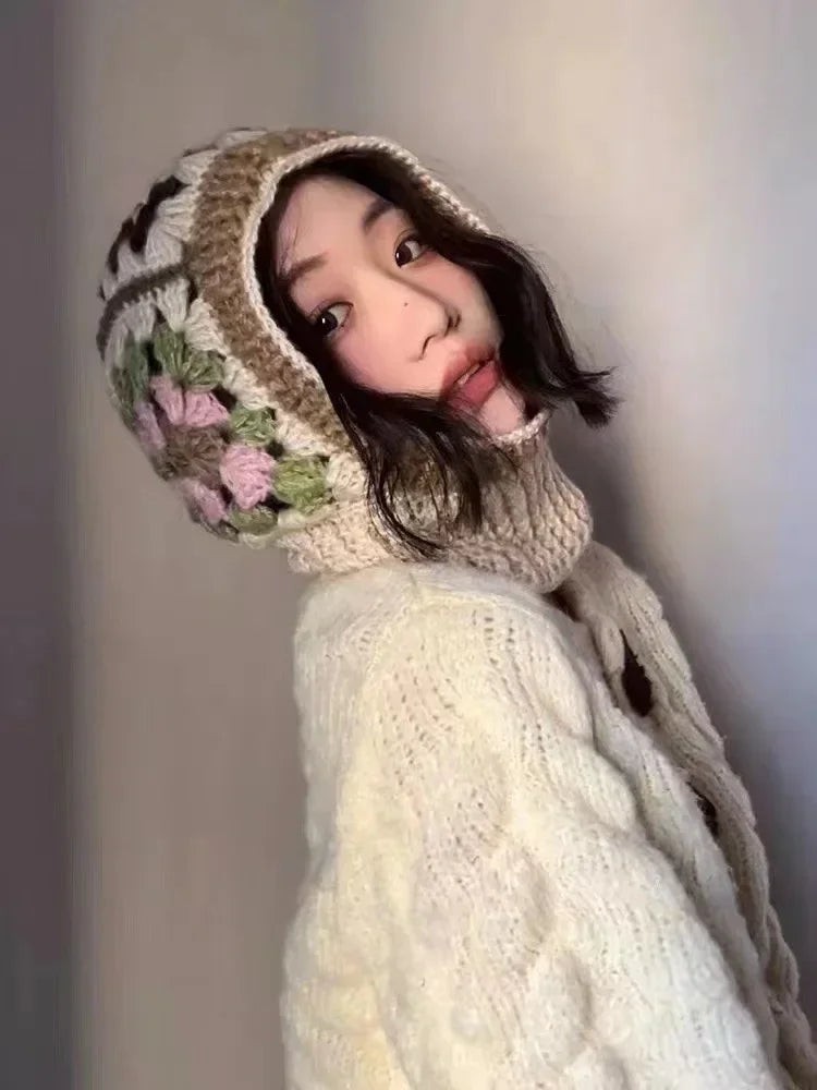 Person with long dark hair wearing a White Knit Balaclava with floral design